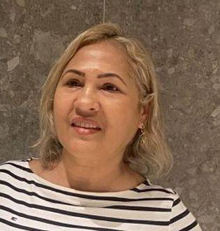 Mulher branca, de cabelos curtos, vestindo blusa com listras horizontais branca e preta